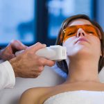 Woman getting Electrolysis Treatment on her face. Horizontal shot.